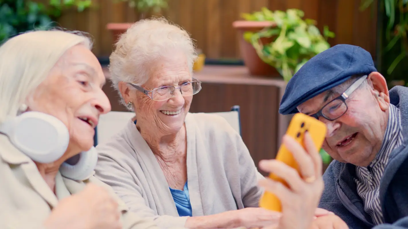 A resident and a team member looking at a phone together