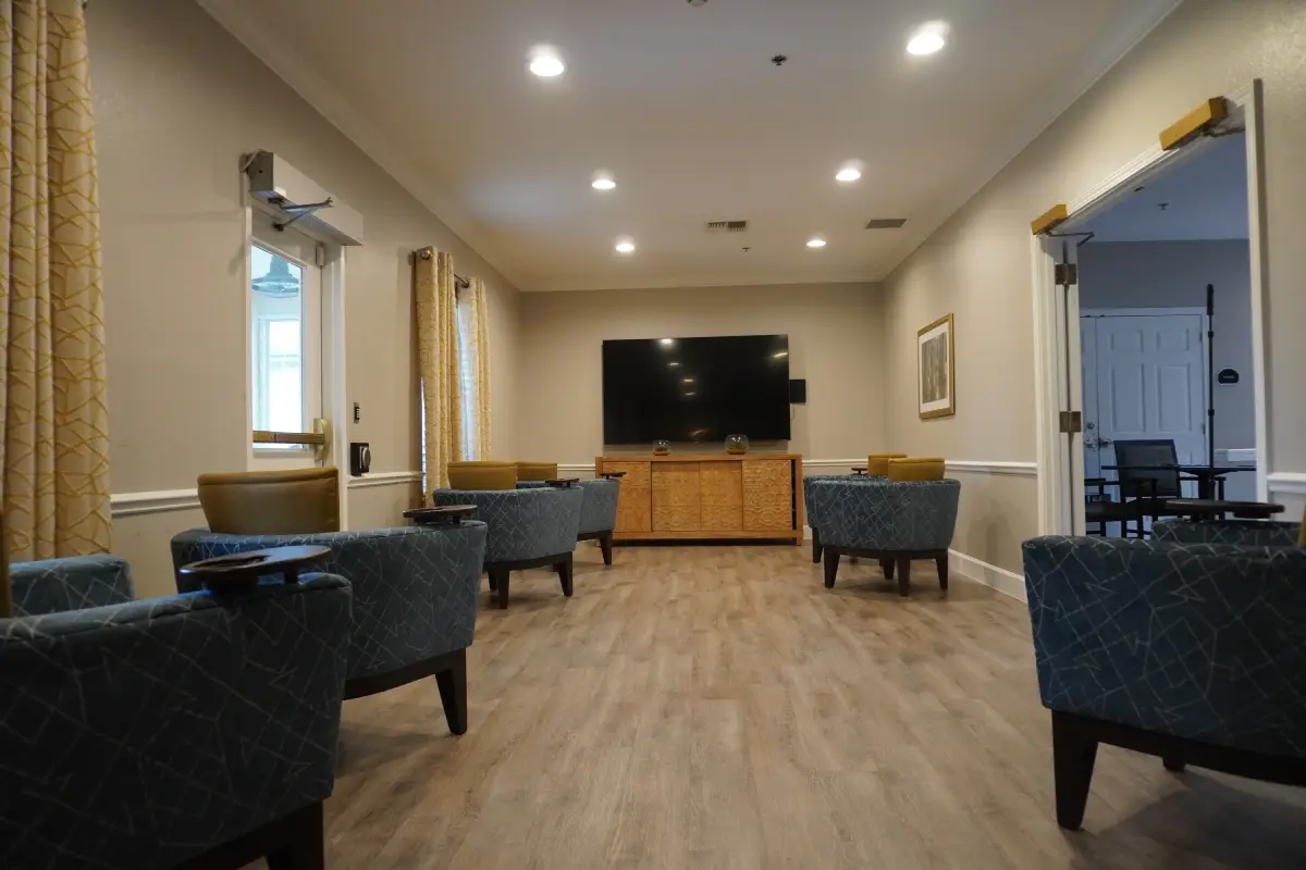 The community theater room with seating facing a screen